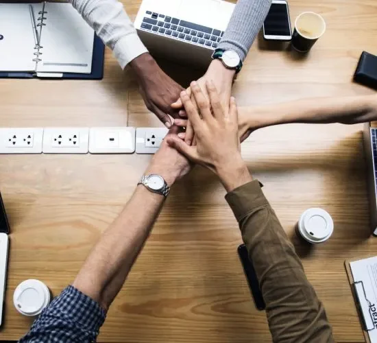 Team of business people stacking hands